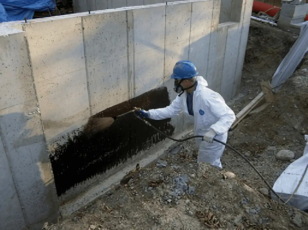 Professional waterproofing the exterior walls of the basement in Cleveland, OH