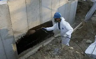 Professional waterproofing the exterior walls of the basement in Cleveland, OH