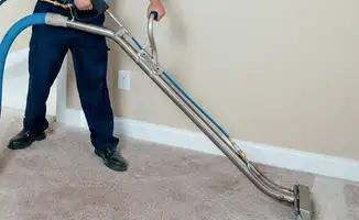 Professional operating a liquid removal machine on a carpeted floor in Cleveland, OH